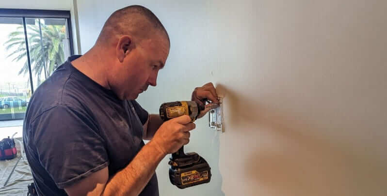 Licensed electrician completing electrical upgrades in a home. 
